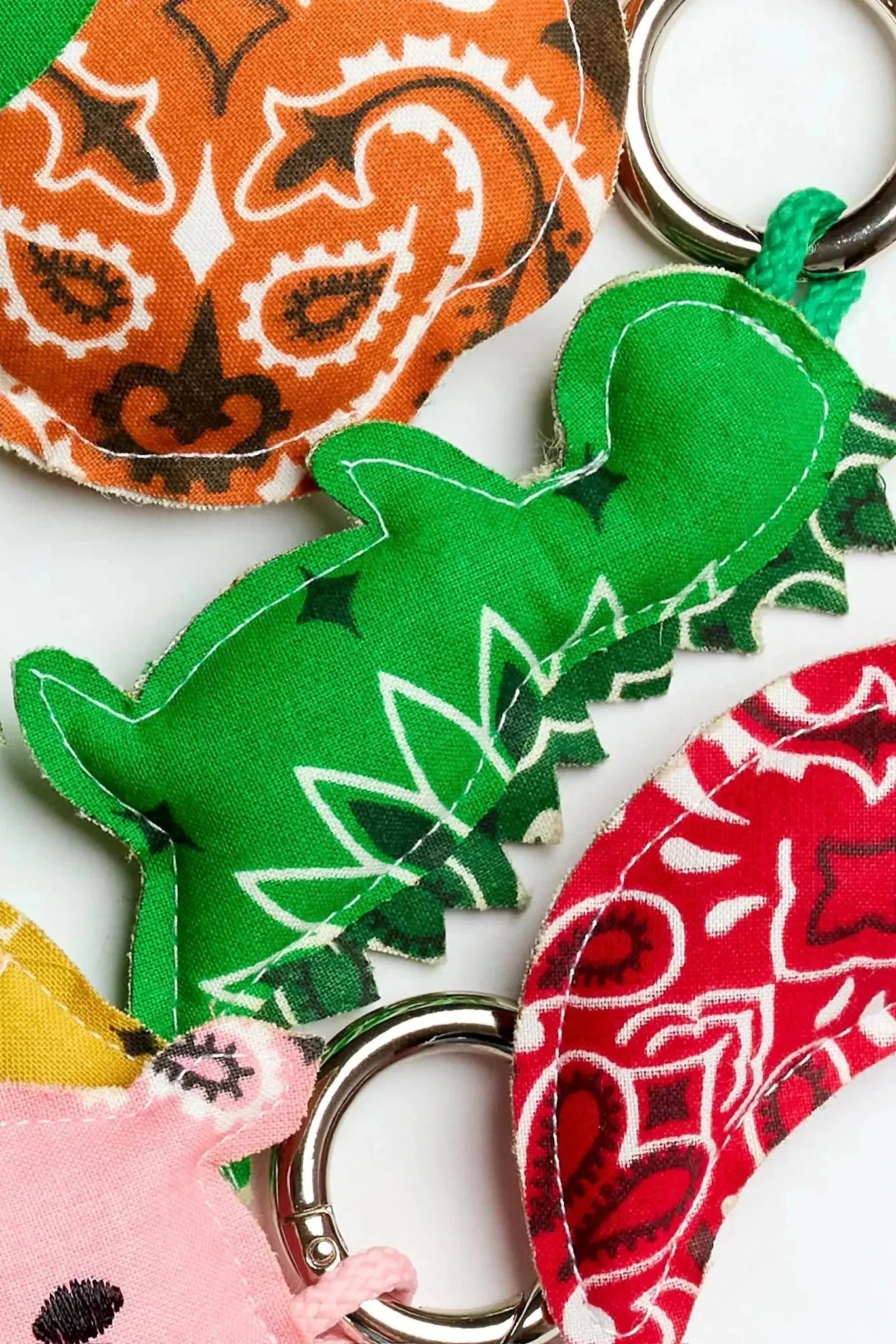 Collection of colorful keychains with various designs on a white background